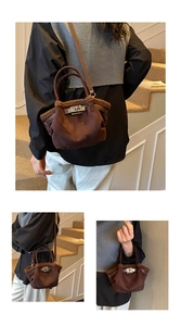 Detail of suede bucket bag with brown faux shearling trim and silver swivel lock