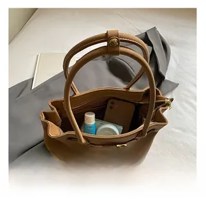Internal view of brown leather tote bag showcasing spacious capacity with daily essentials