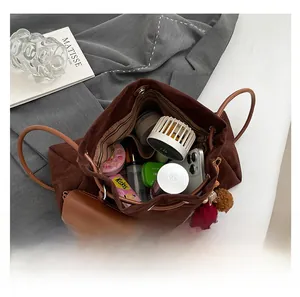 Spacious dark brown suede tote bag showing internal storage for daily essentials