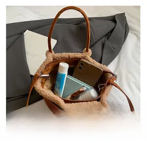 Top view of suede tote showing inner capacity with phone, wallet and cosmetics