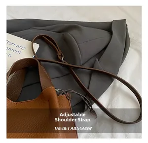 Détail du sac seau en cuir marron grainé avec une bandoulière réglable pour le porter