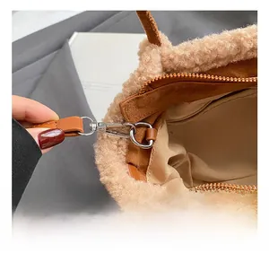 Close-up of premium silver metal swivel hook and plush faux shearling trim on tote bag
