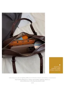 Top view showing the spacious interior of the brown leather bag with daily essentials