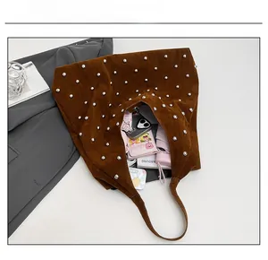 Detail showing internal capacity of the brown suede tote bag with stylish silver rivets