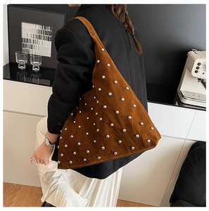 Brown suede shoulder bag with silver rivet details shown styled on a female model