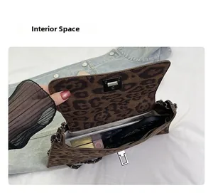 Detailed interior of the leopard print crossbody bag showing space for phone and makeup