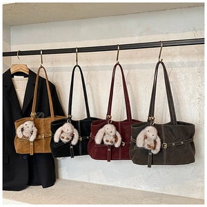 Detail view of suede tote bags in four colors with stitching and cute bunny charms