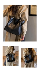 Detail of black faux leather tote with textured finish and gold chain shoulder strap