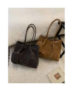 Detail view of large matte tote bags with matching coin purses in dark brown and caramel