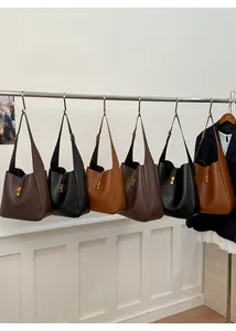 Detail view of large matte leather bucket bags with gold locks in multiple colors