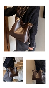 Close-up of textured dark brown leather tote bag featuring elegant gold chain straps