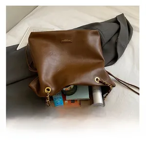 Detailed view of large brown bucket bag interior showing spacious storage for daily essentials