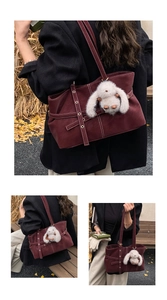 Detail of burgundy suede tote bag with metal eyelet straps and white bunny charm