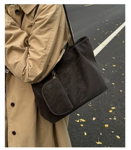 Detail of vintage matte leather tote bag with matching inner pouch on model