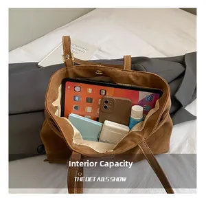 Detail view of the brown tote bag interior showing capacity for iPad and essentials