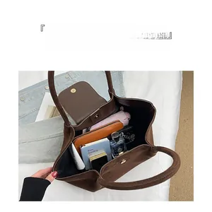 Spacious interior of dark brown suede tote bag showing everyday essentials storage