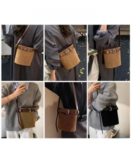 Three bucket bags in brown and black with leather belt buckle and adjustable shoulder strap