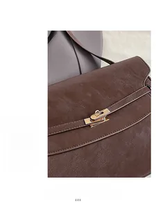 Detailed macro view of dark brown pebbled leather texture and gold twist-lock closure