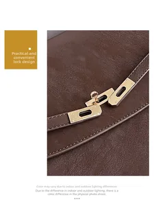 Detail of golden twist lock closure and premium lychee grain leather on brown handbag