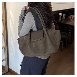 Detail of dark olive suede tote bag showing large capacity and soft texture