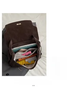 Top view of large dark brown leather tote interior showing spacious capacity with personal items