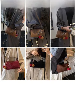 Trois sacs en daim mat marron, bordeaux et noir avec un pompon décoratif en fourrure