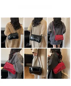 Detail showing red and black patent leather shoulder bags with elegant wave-cut flaps