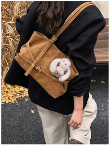 Brown suede tote bag detail featuring adjustable strap and cute plush bunny charm
