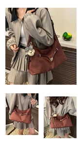 Close-up of deep burgundy suede tote bag with leopard print bear charm and vintage buckles
