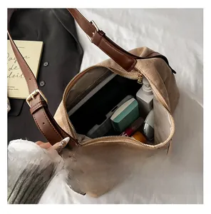 Detailed interior view of a beige dumpling bag showing large capacity for essentials