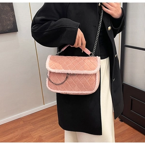 Detailed view of pink quilted handbag with plush lamb wool trim and gunmetal chain strap