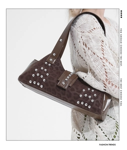 Close-up of leopard print shoulder bag featuring silver stud details and shiny leather texture