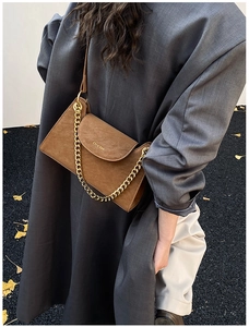 Detail of brown suede crossbody bag with gold chain and Chris'2ab brand engraving
