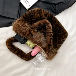 Faux fur leopard handbag showing large capacity for phone, umbrella, and water bottle