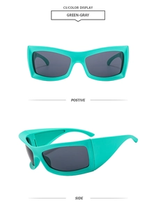 Detail view of mint green chunky cat eye sunglasses with grey lenses and thick frame