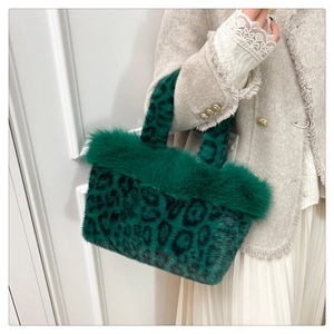 Detail of green leopard print plush handbag with fluffy faux fur trim and dual handles