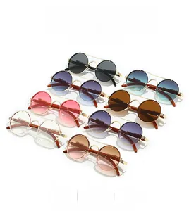 Detail view of double bridge sunglasses with leopard metal relief and wood texture temples