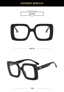 Detail view of square black frame glasses showing front and side profile with silver logo