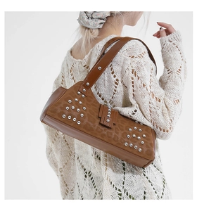 Detail of brown leopard print shoulder bag with silver studs and wide strap on model
