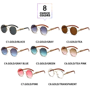 Close-up of retro round double-bridge sunglasses with gold cheetah head metal temples
