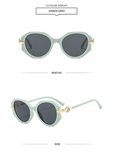 Detail of round frame sunglasses in mint green with gold accents and gray lenses