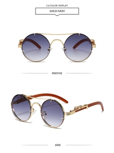 Detail of vintage round metal sunglasses with leopard head emblem and gradient lenses