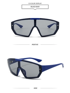 Detailed view of oversized shield sunglasses in blue and gray with a retro-future design