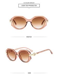 Detail view of light tea oversized geometric sunglasses with gold metal hinges