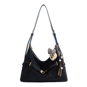 Fashionable black suede hobo tote bag with plush bear charm and chic leopard bow