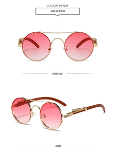 Detail of gold metal sunglasses with pink gradient lenses and leopard head relief