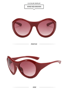 Detail view of wine red oversized sunglasses with thick frames and gradient lenses