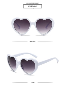 Detail view of white heart shaped sunglasses with grey gradient lenses from two angles