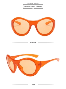 Detail view of orange Y2K oval sunglasses with transparent frames and matching lenses