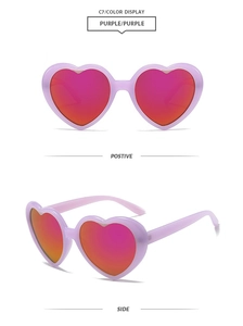 Close-up of heart-shaped sunglasses featuring purple frames and red mirrored lenses
